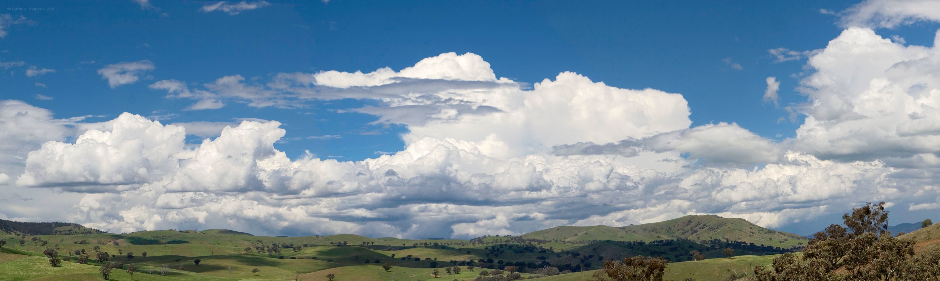 Rolling green hills under cloudy sky