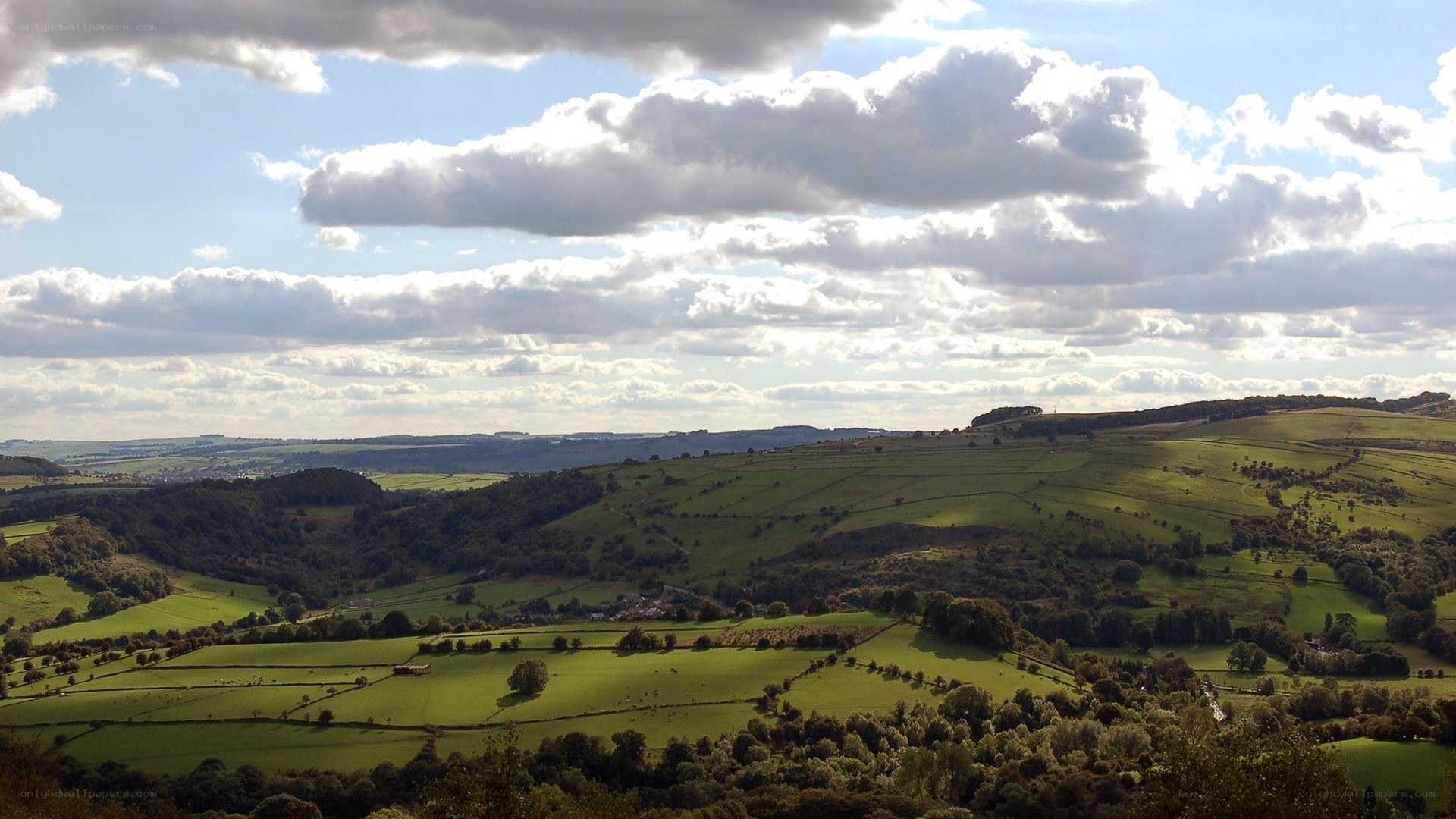 rolling green hills under cloudy sky