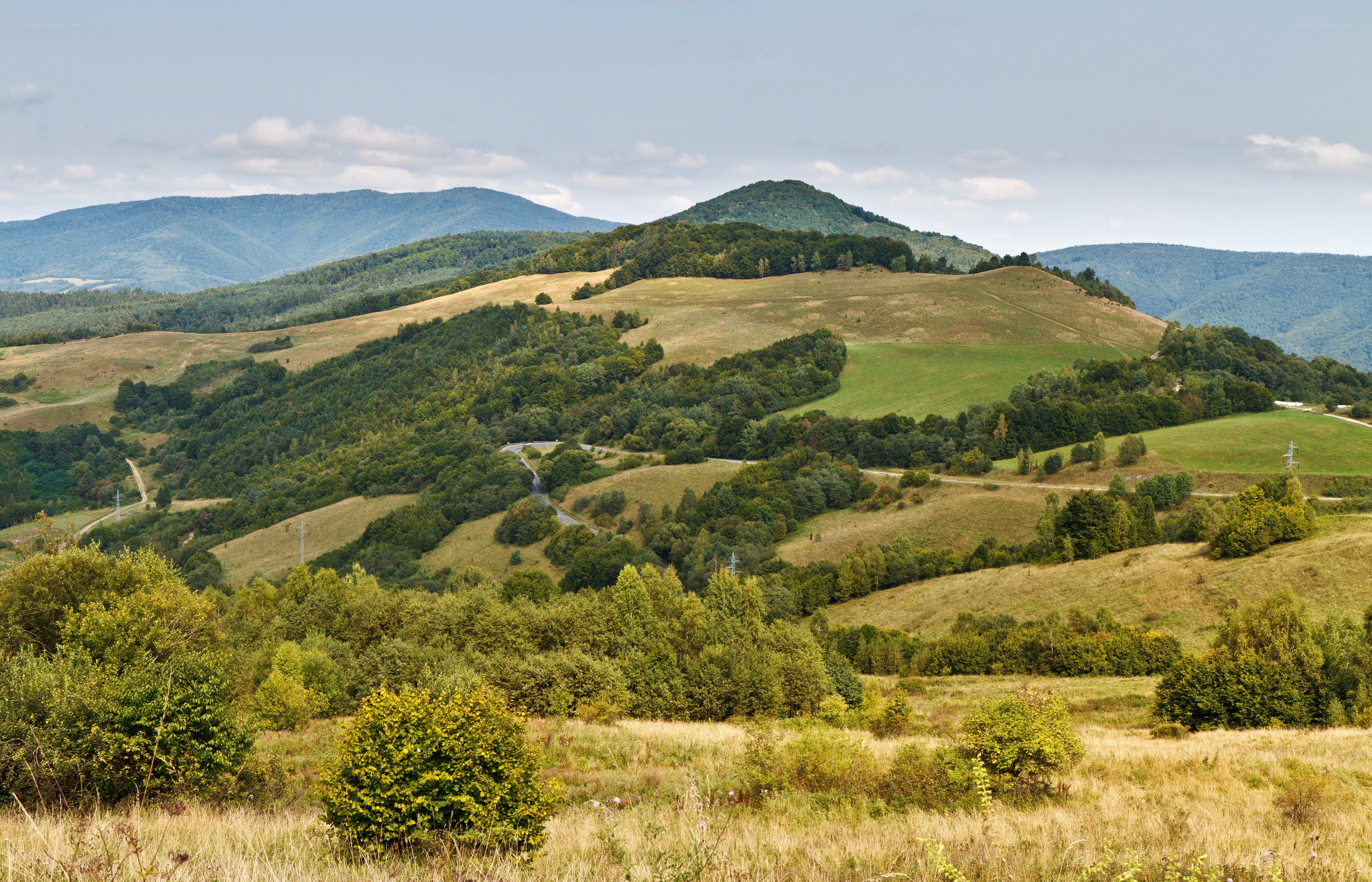Rolling hills and distant mountains
