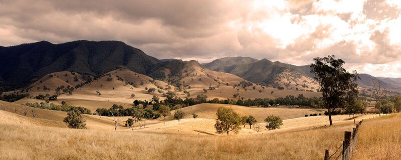 Rolling hills under cloudy sky