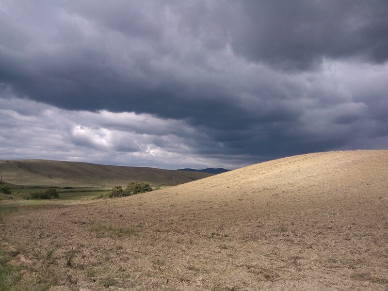 Rolling Hills under Storm Clouds — Gray