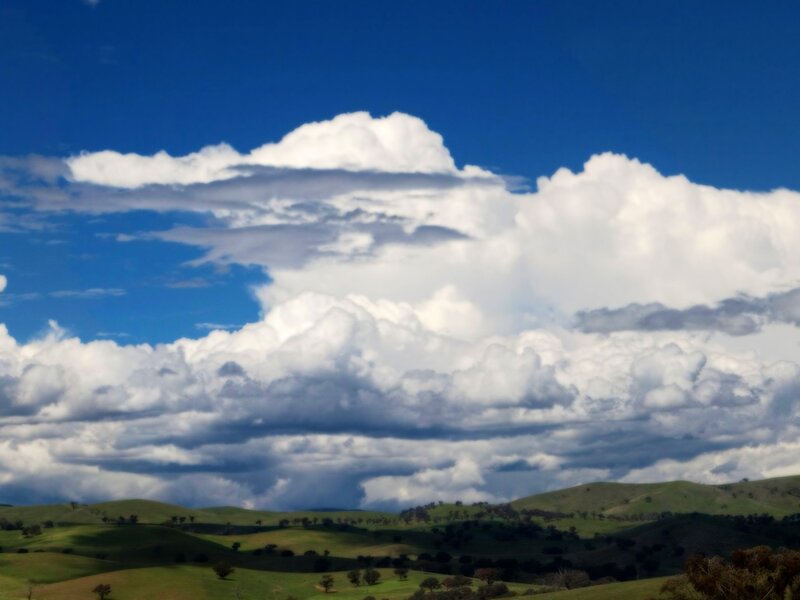 Rolling hills under storm clouds