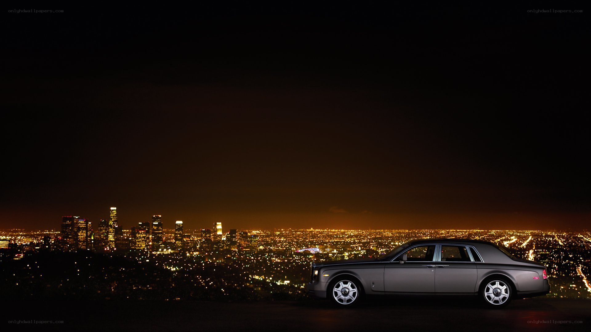 Rolls-Royce at night with city view