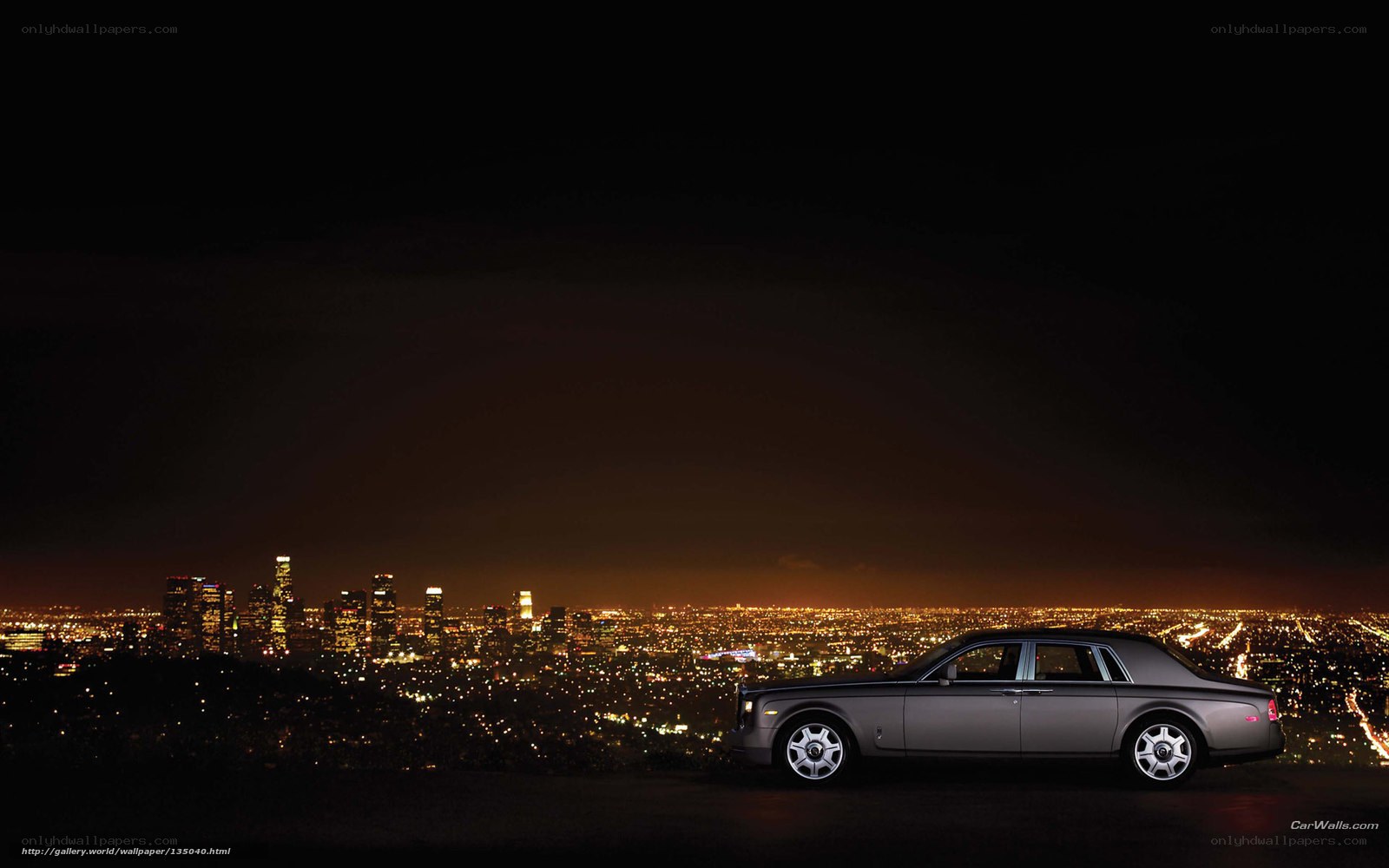 Rolls-Royce at night with city view