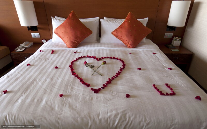 Romantic bed with rose petals