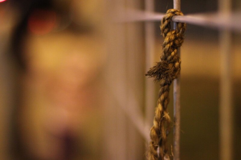 rope tied to a metal bar