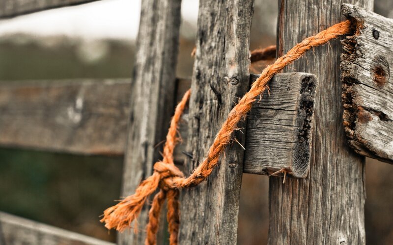 Rope tied to wooden fence