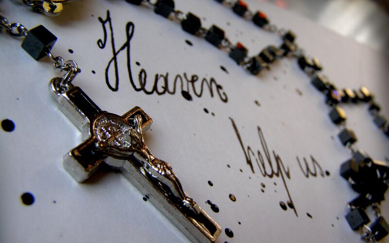Rosary with crucifix on paper