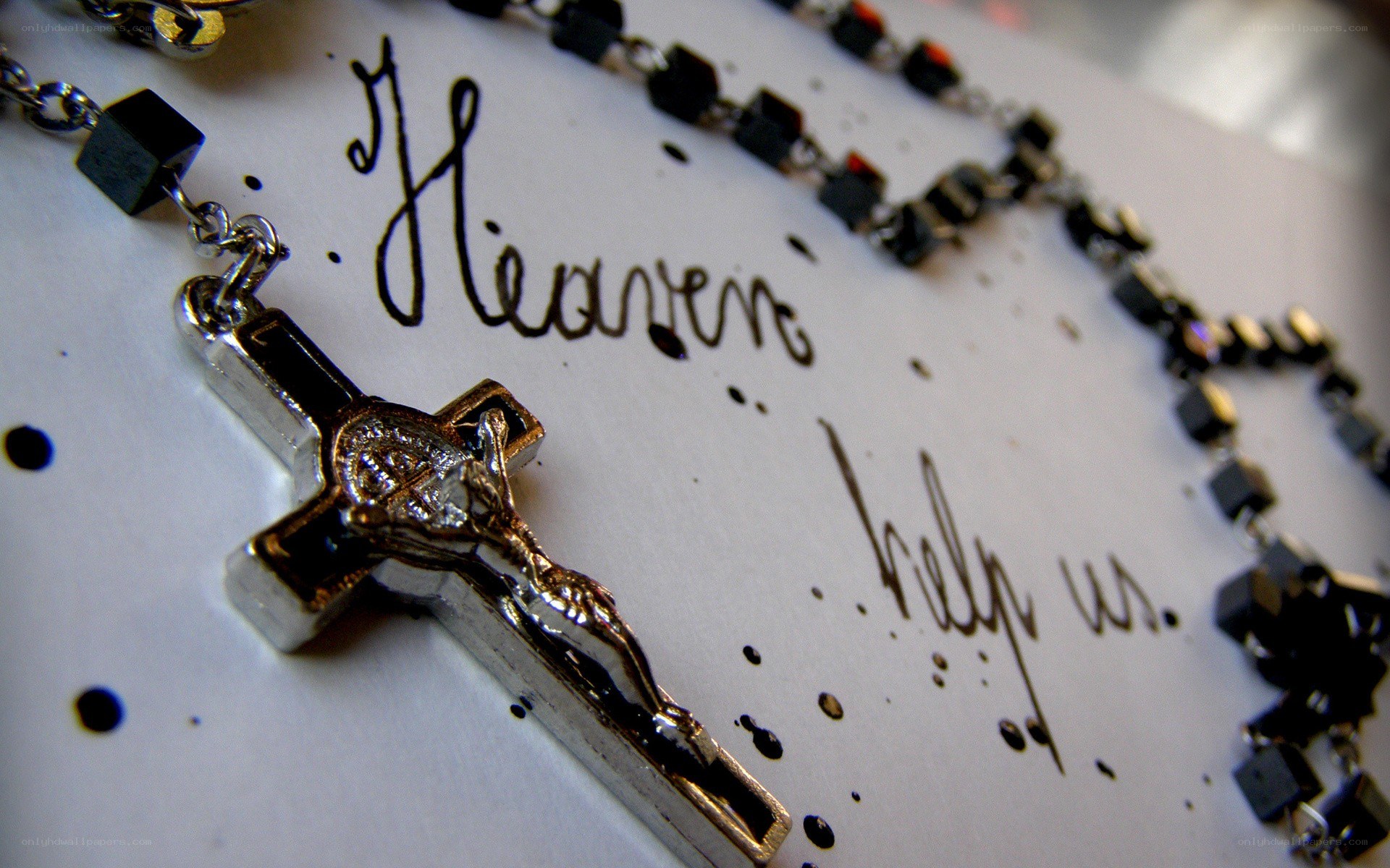 Rosary with crucifix on paper