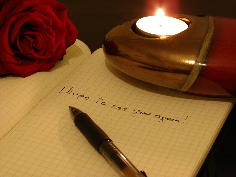 Rose and candle on notebook