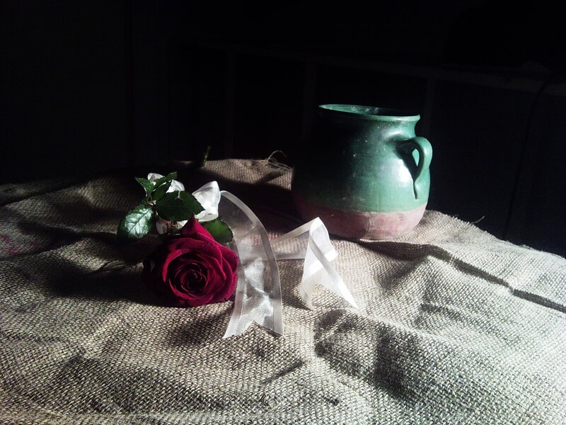 rose and green jug on burlap