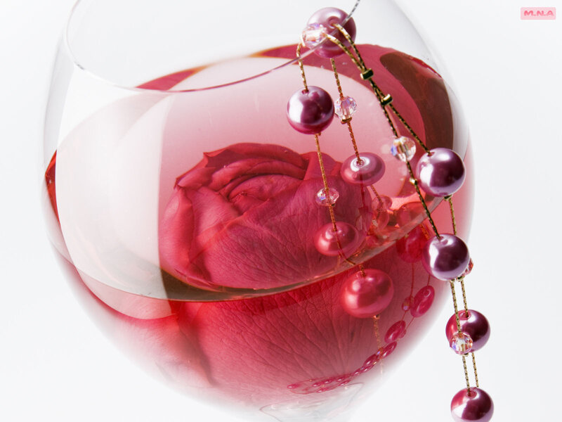 rose in wine glass with beads