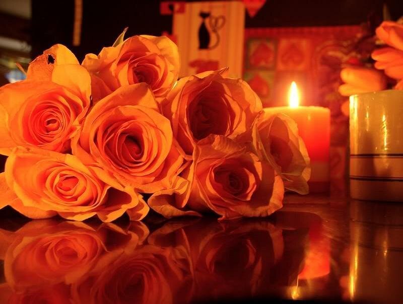 roses and candles on a table