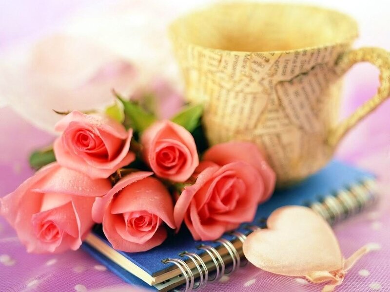roses and cup on notebook