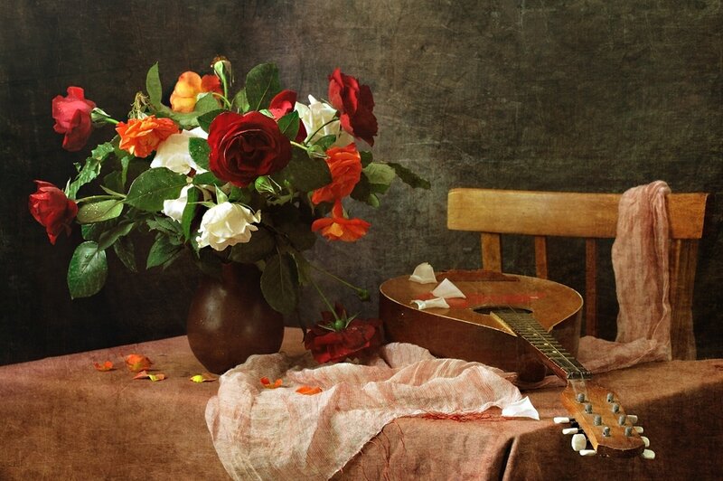 Roses and guitar on table