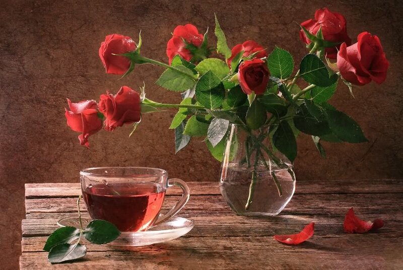 Roses and tea on wood