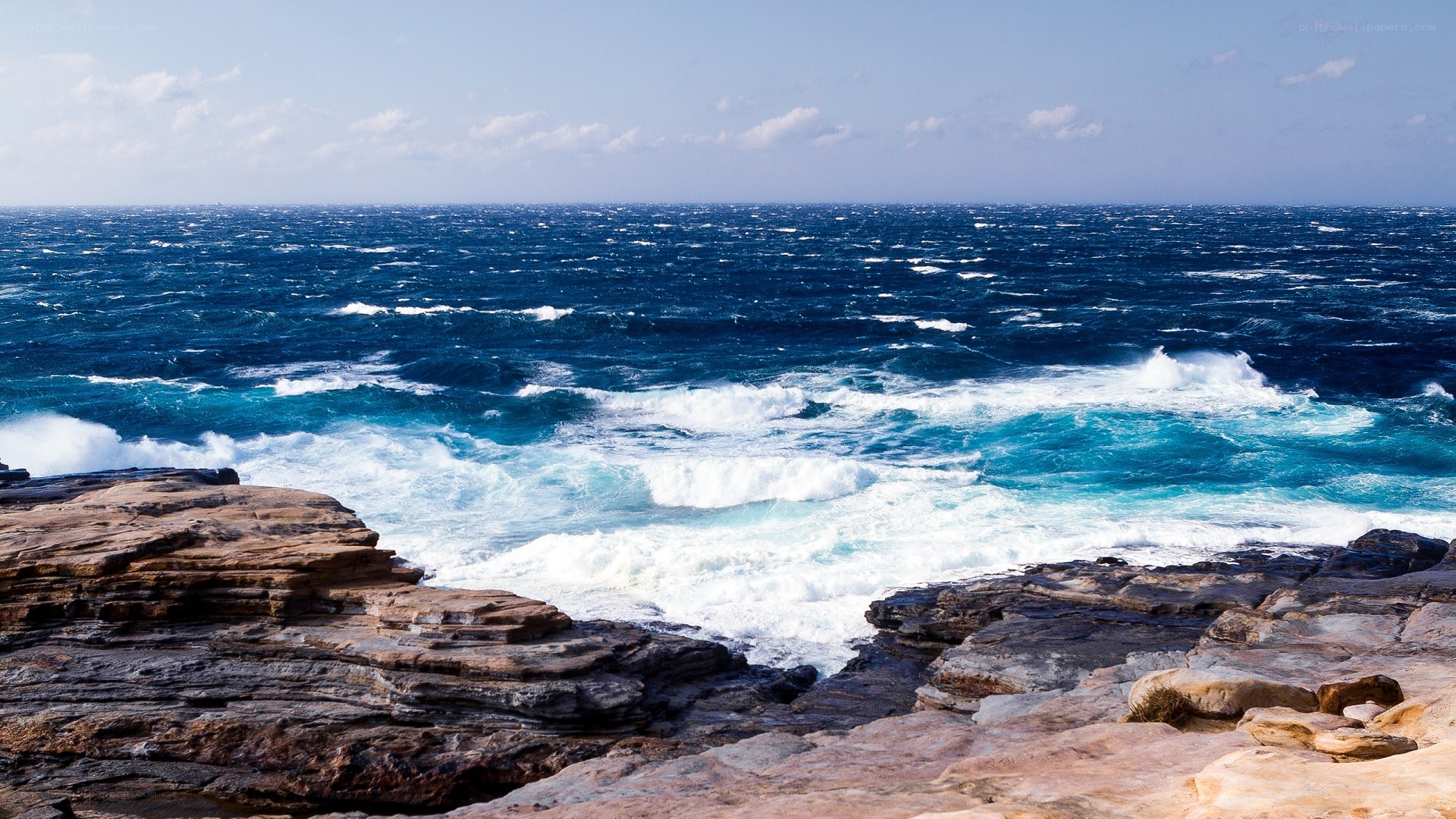 Rough ocean waves crashing on rocks