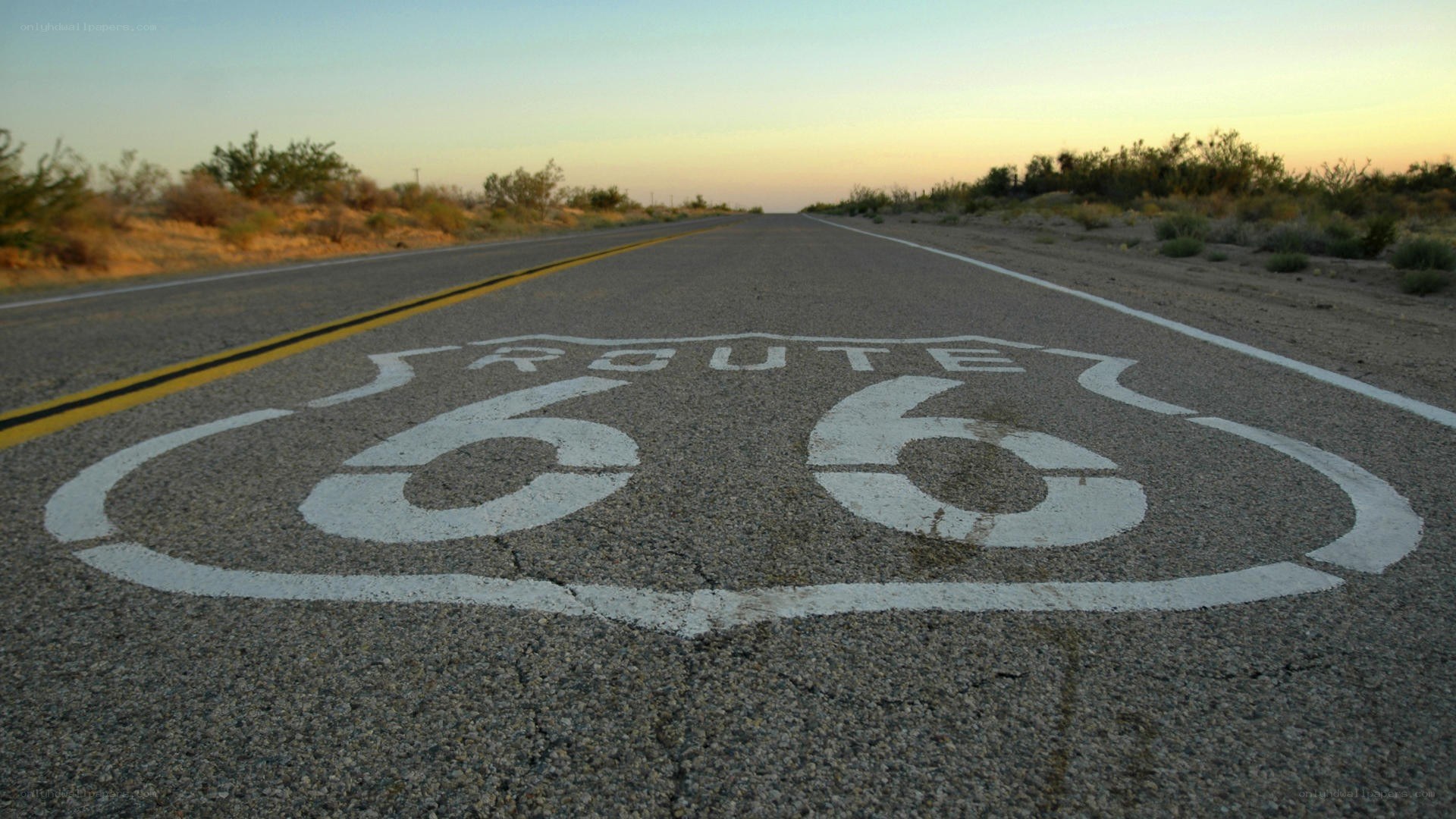 Route 66 road sign at sunset