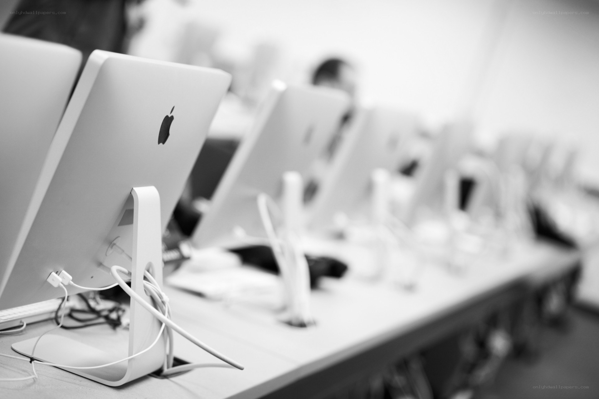 Row of Apple computers in a classroom