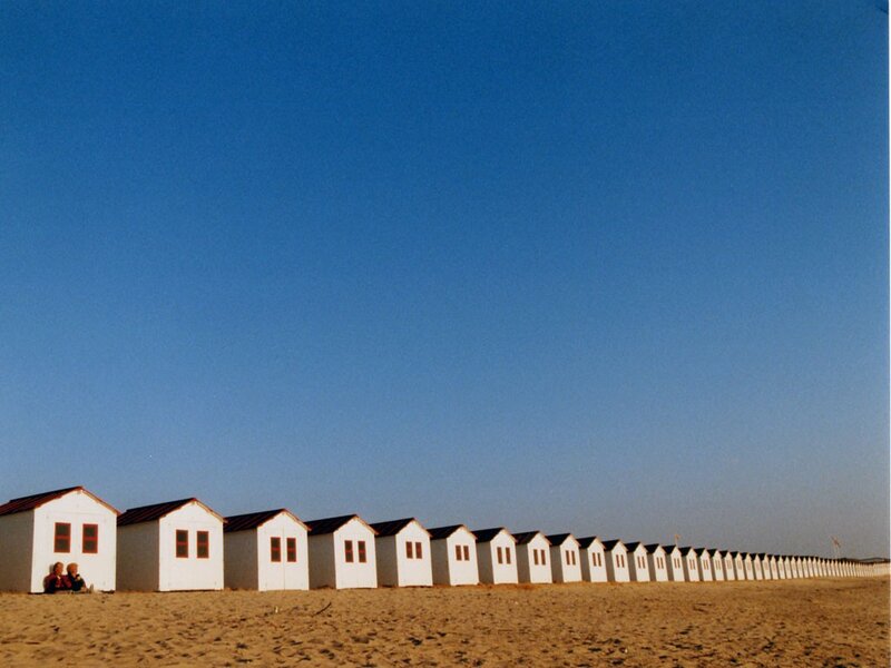 Row of beach huts on sand