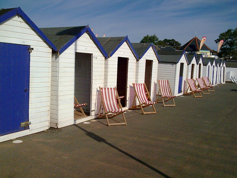 Row of beach huts with deck chairs