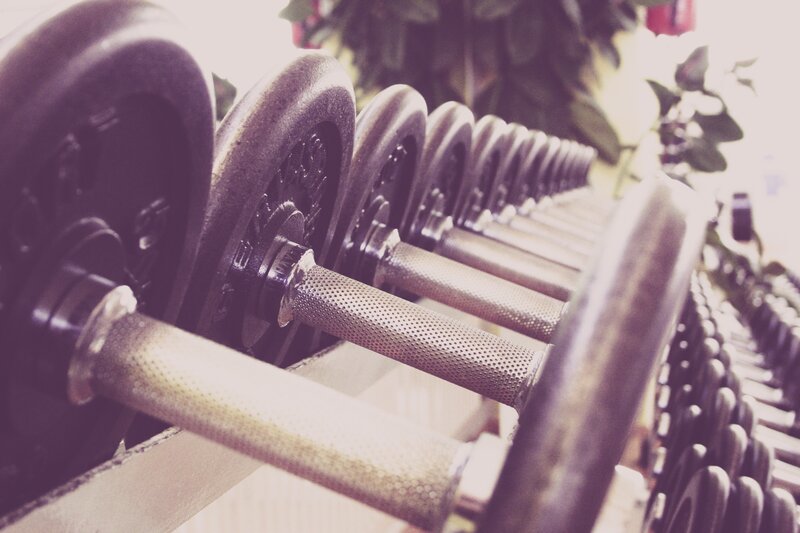 Row of dumbbells in gym