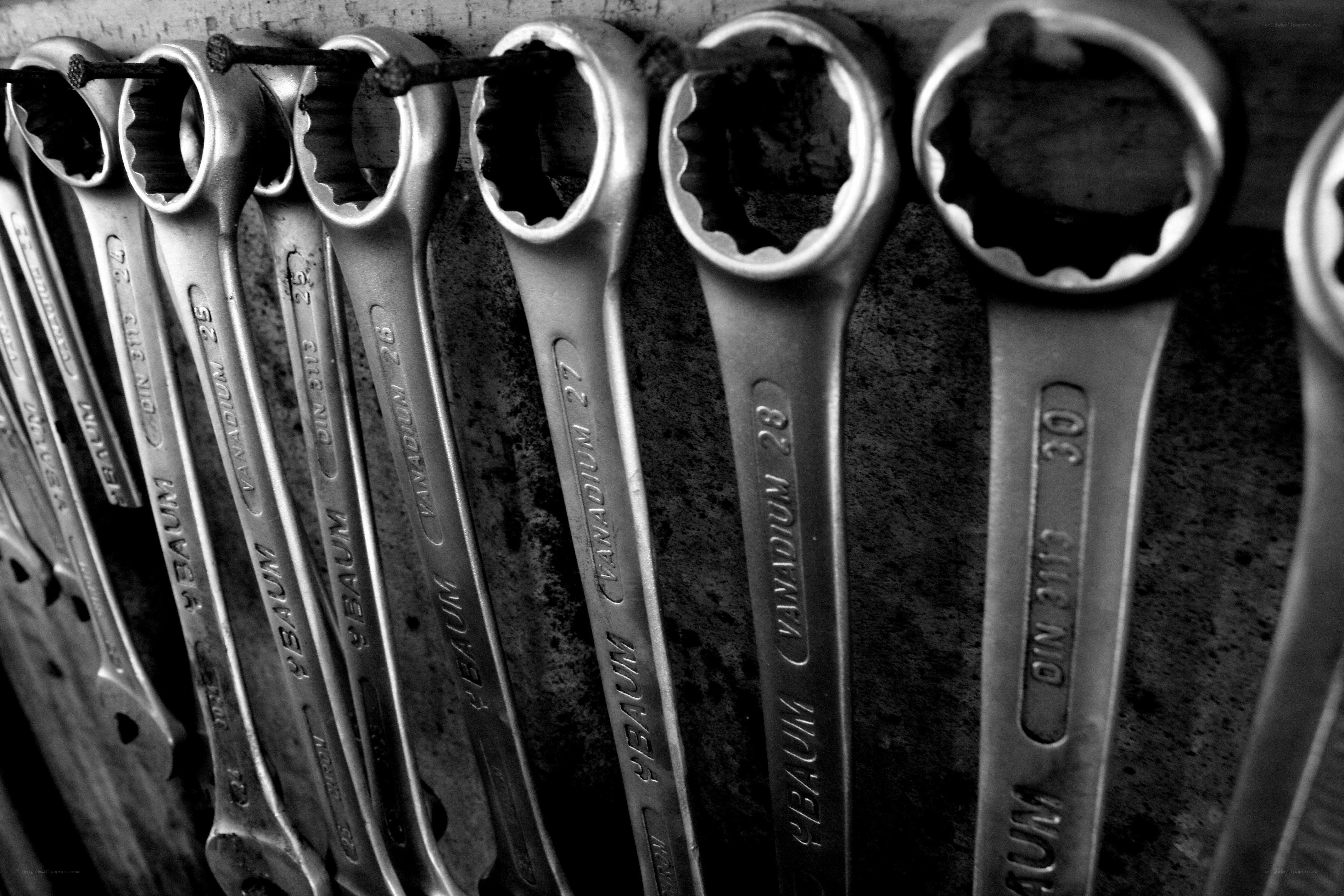 row of wrenches on a wall