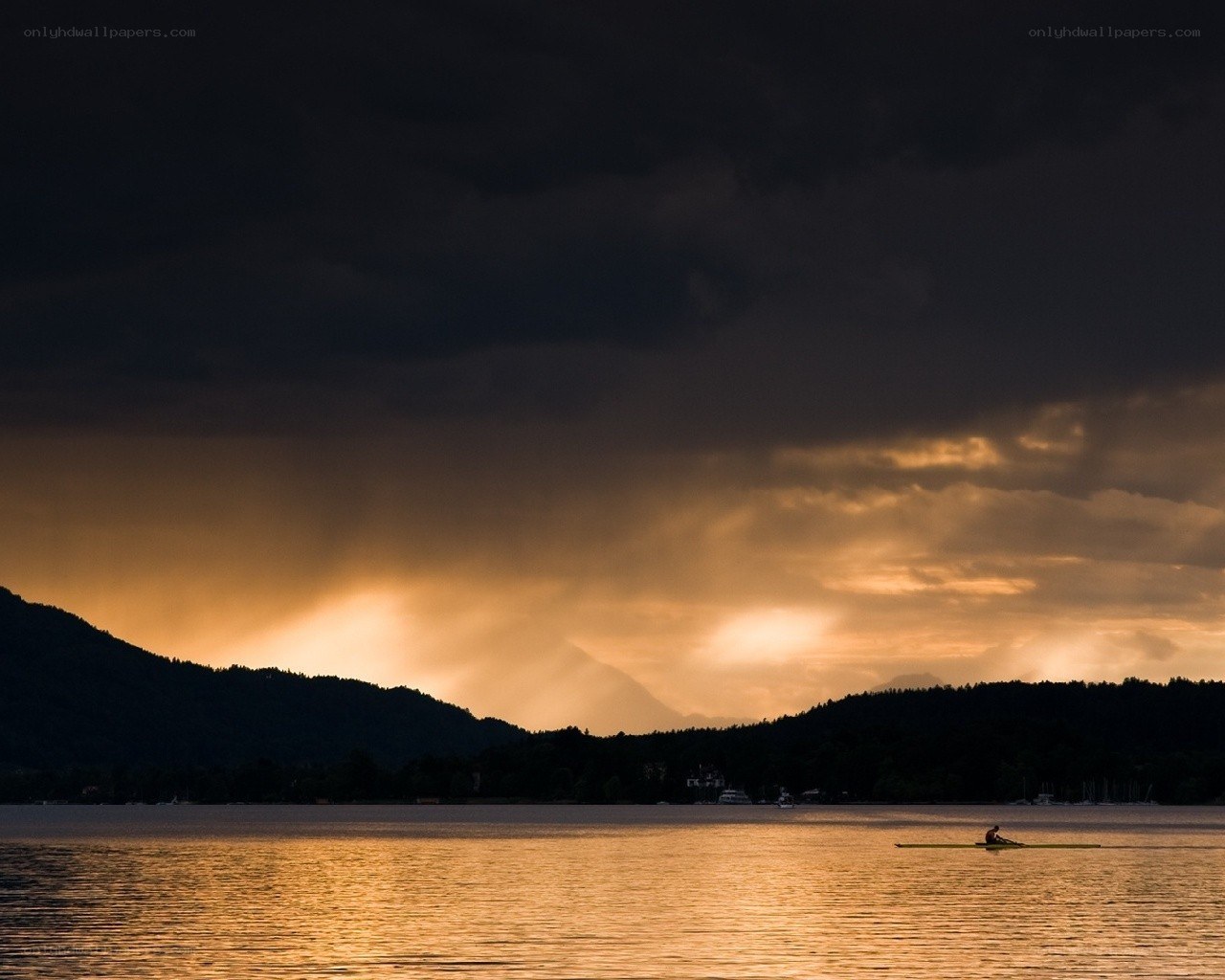 Rowing at sunset on a lake