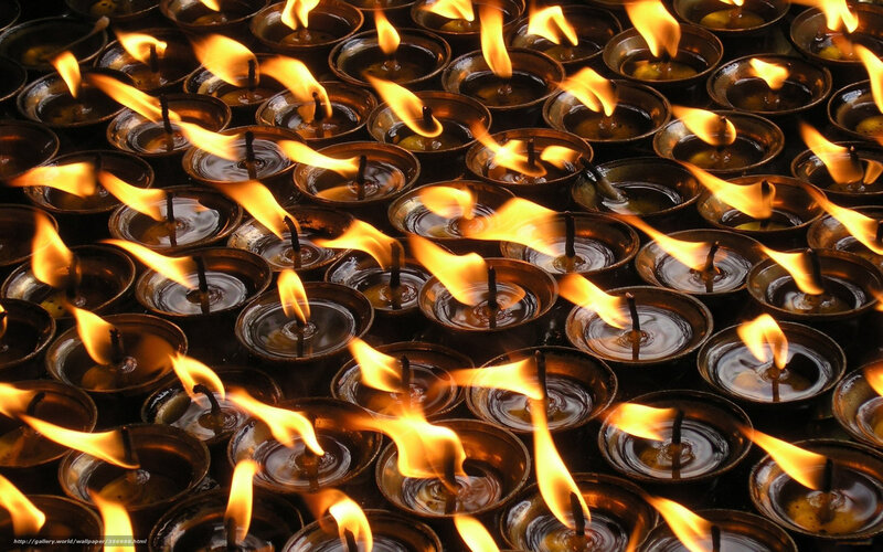 Rows of lit oil lamps