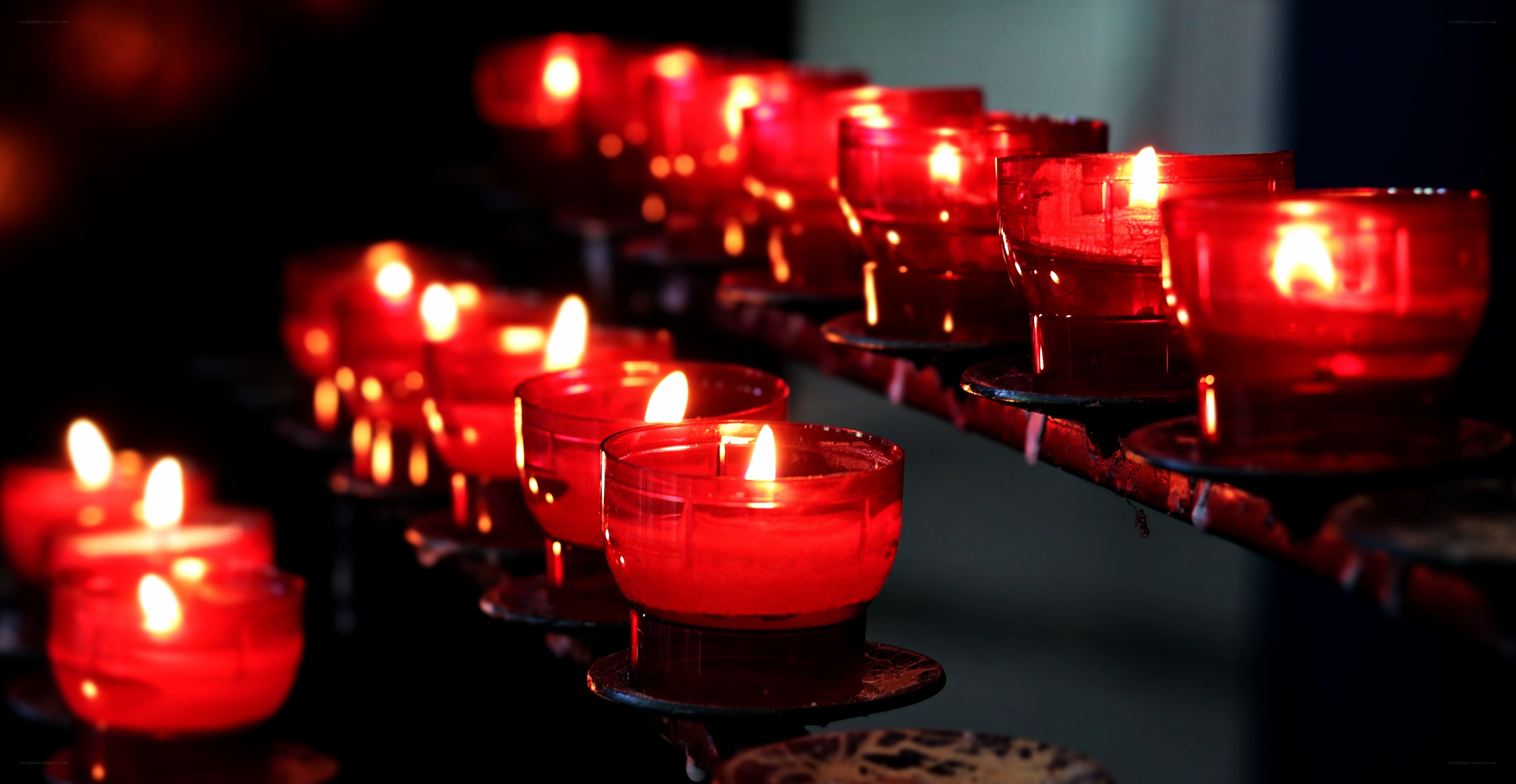 Rows of lit red candles