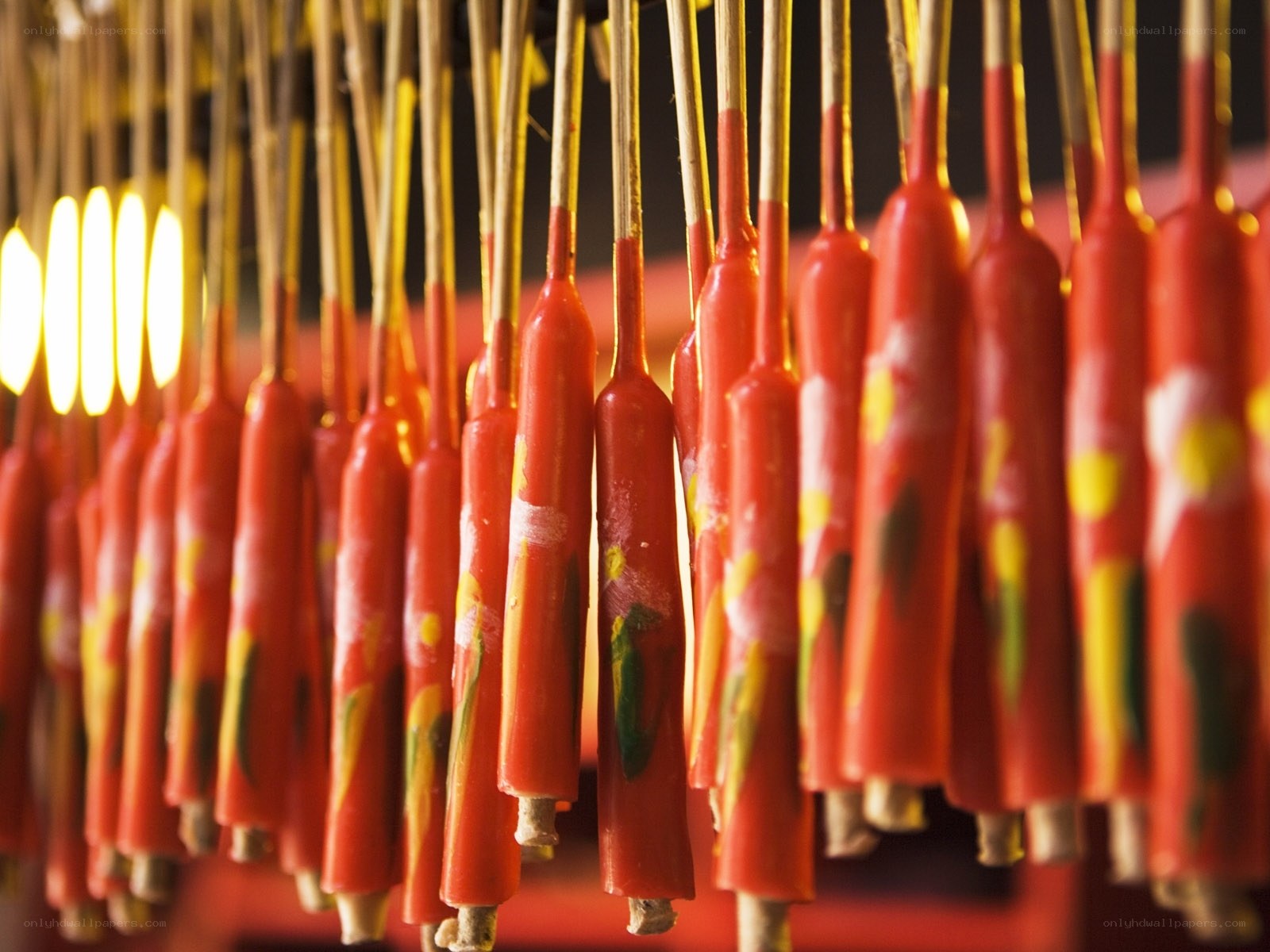 Rows of red candles on sticks