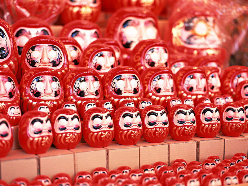 Rows of red daruma dolls