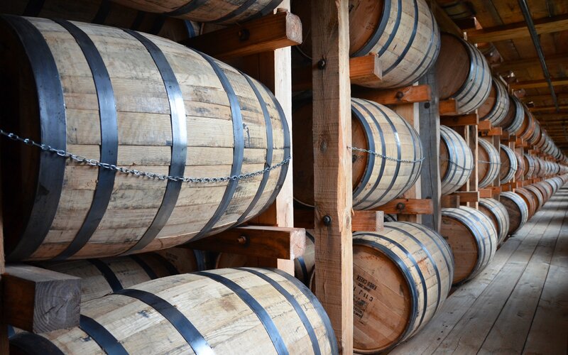 Rows of wooden barrels in a warehouse