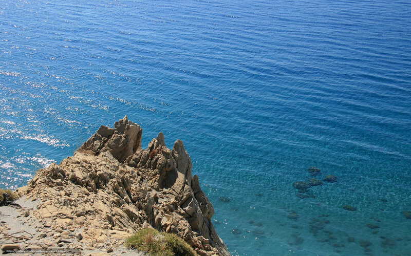 Rugged cliff overlooking blue sea