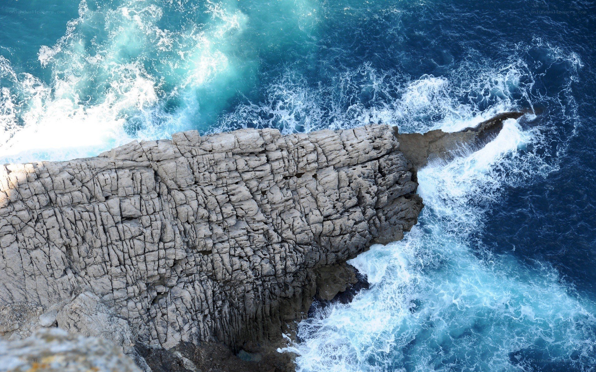 Rugged cliff overlooking crashing waves