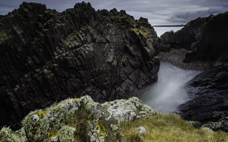 Rugged coastal rocks and flowing water