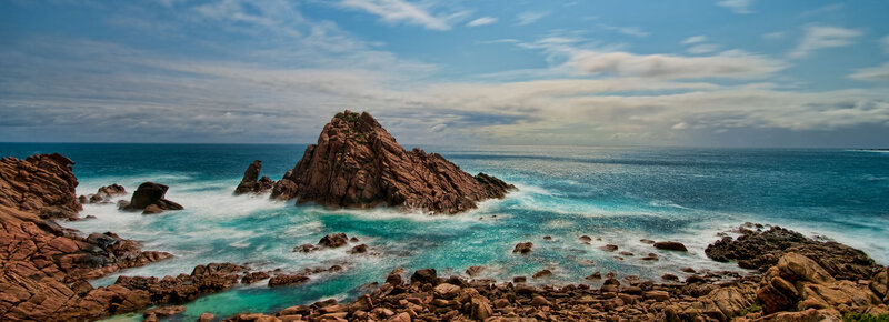 Rugged coastal rocks and turquoise waves