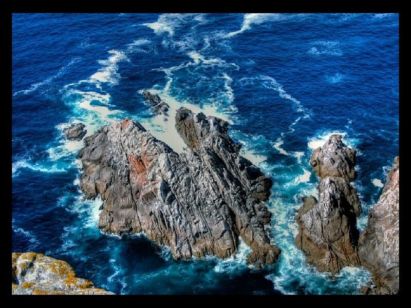 Rugged coastal rocks in blue sea