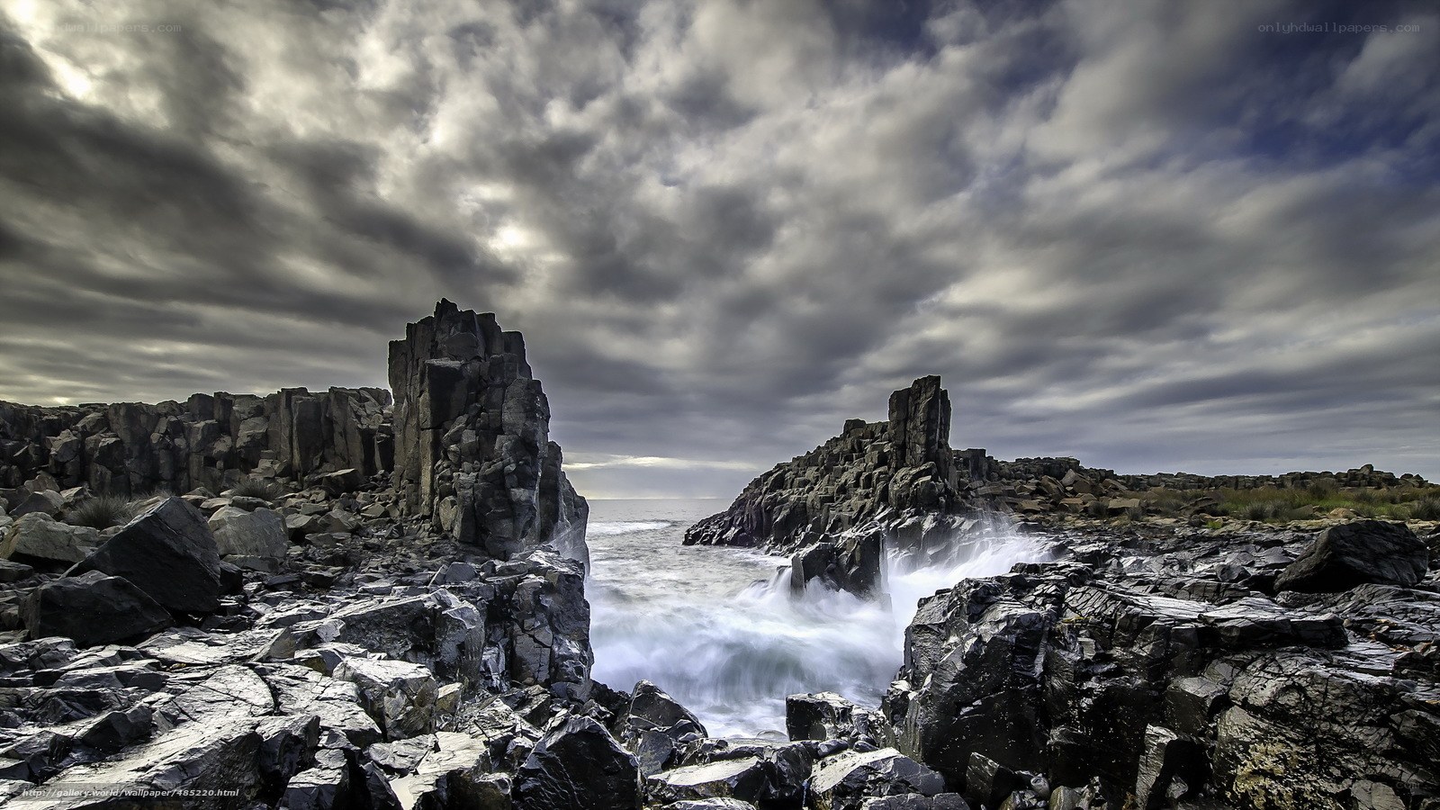 Rugged coastal rocks under stormy sky