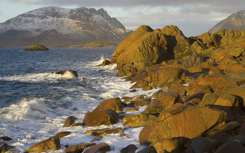 Rugged coastline with snow-capped mountains