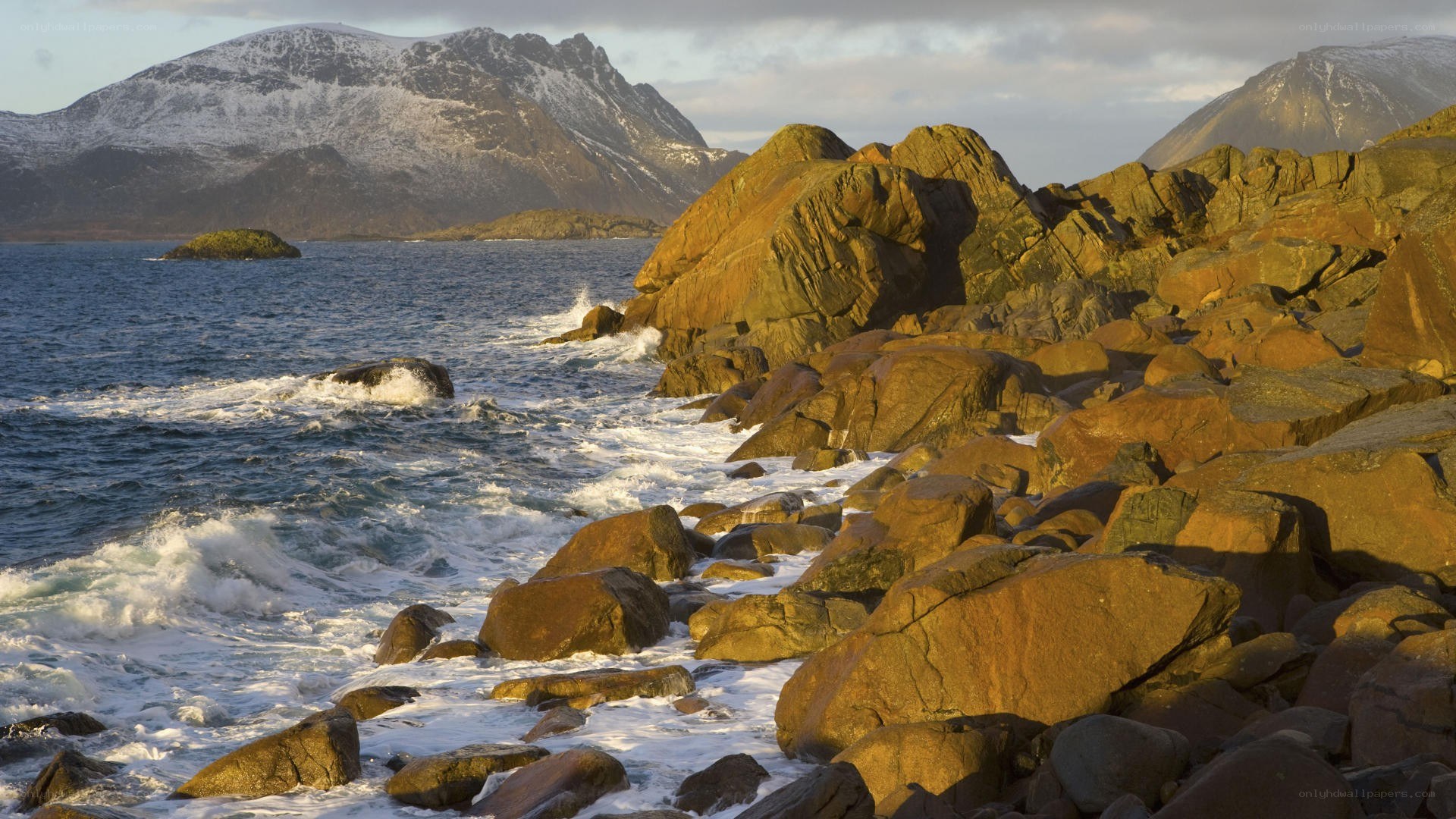 Rugged coastline with snow-capped mountains