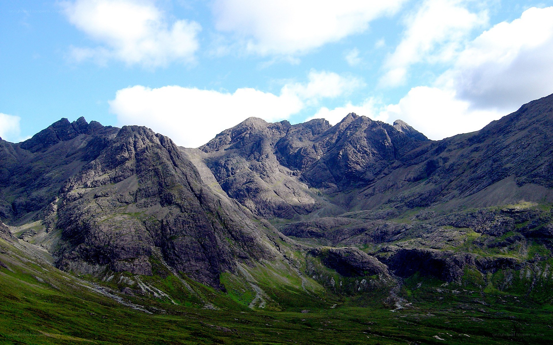 Rugged mountain peaks under blue sky