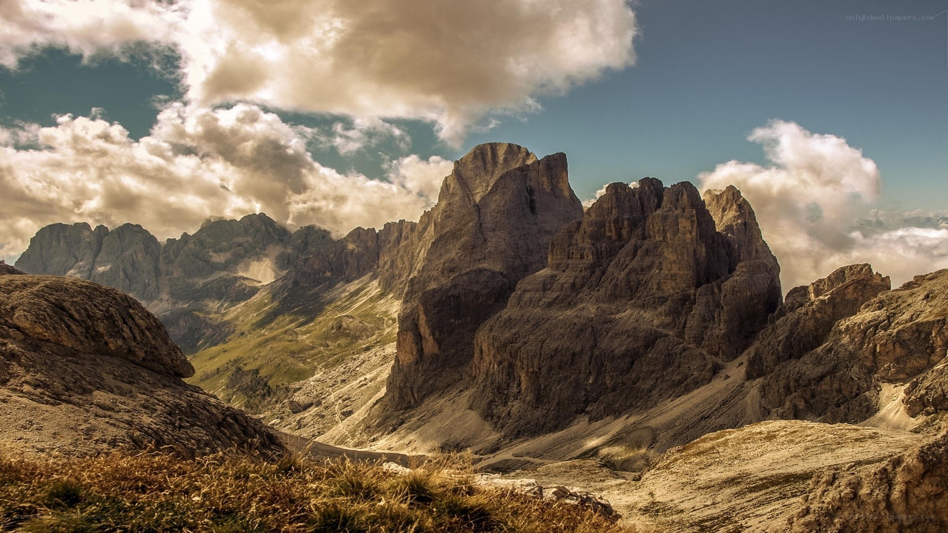 Rugged mountain peaks under cloudy sky