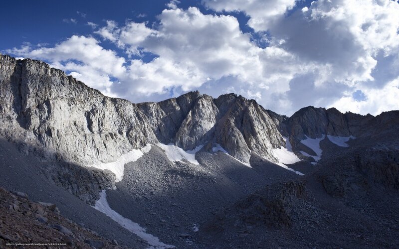 Rugged mountain peaks under cloudy sky
