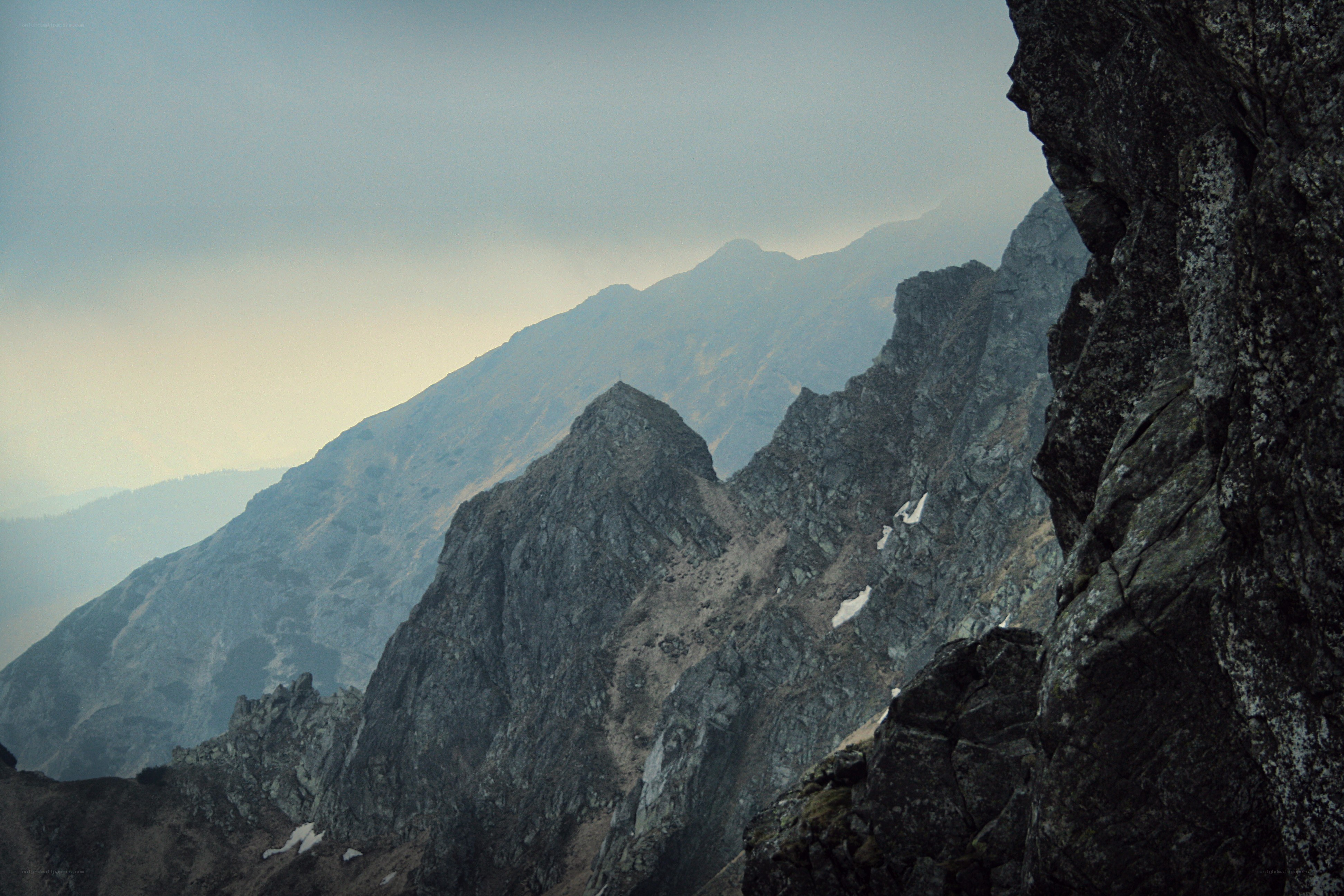 Rugged mountain peaks under overcast sky