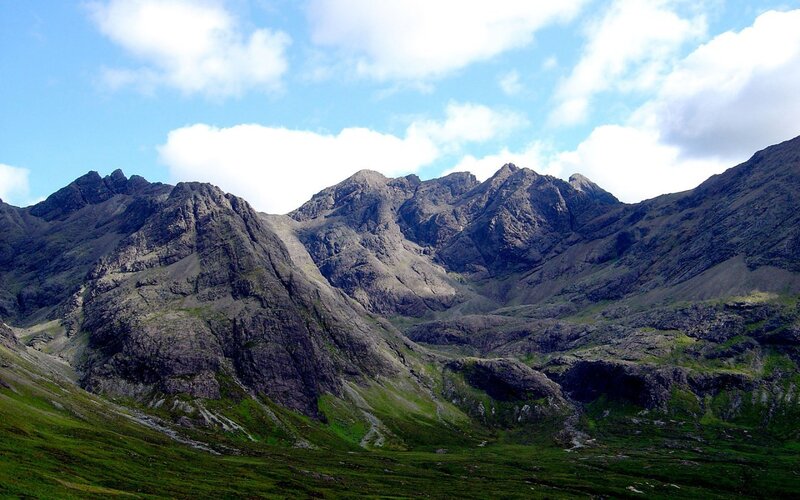 rugged mountain range under cloudy sky