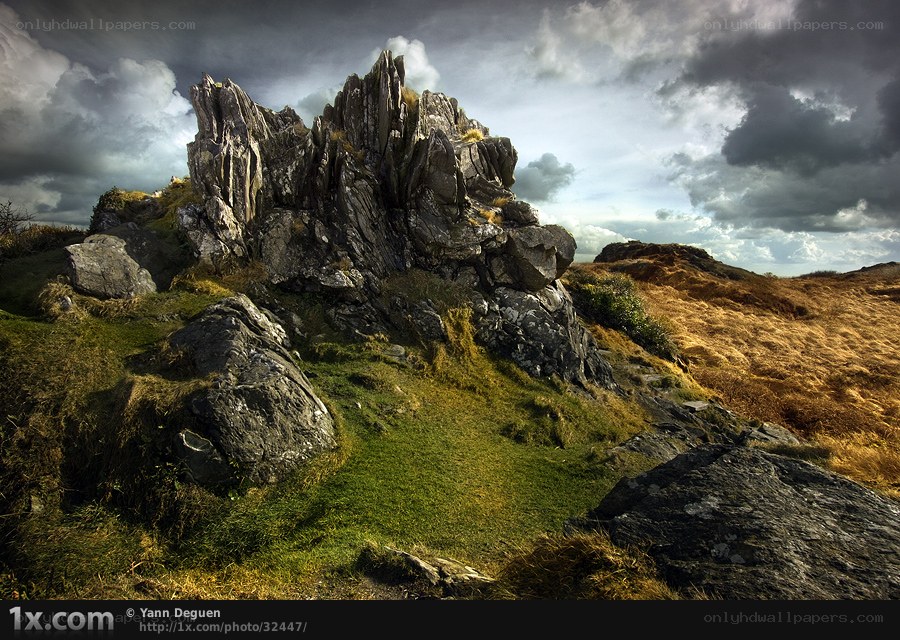 Rugged rock formation under stormy sky