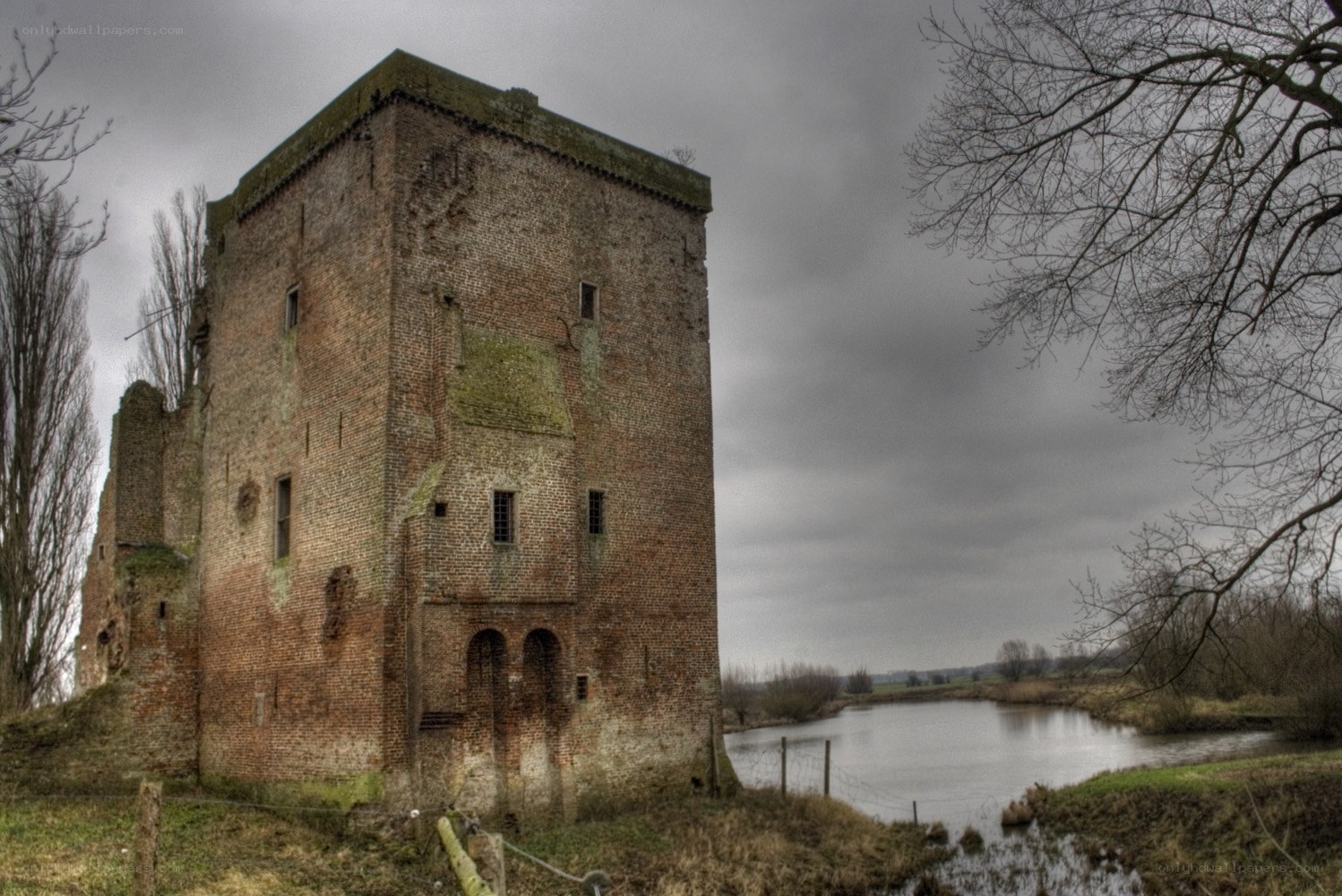 ruined brick tower by a river