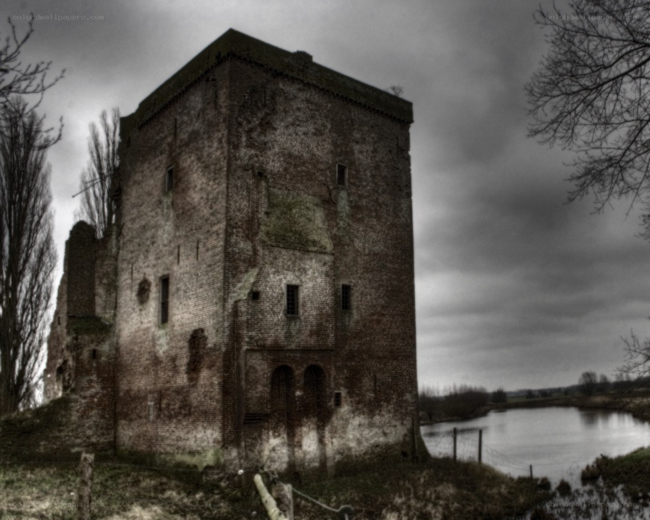 ruined brick tower by a river