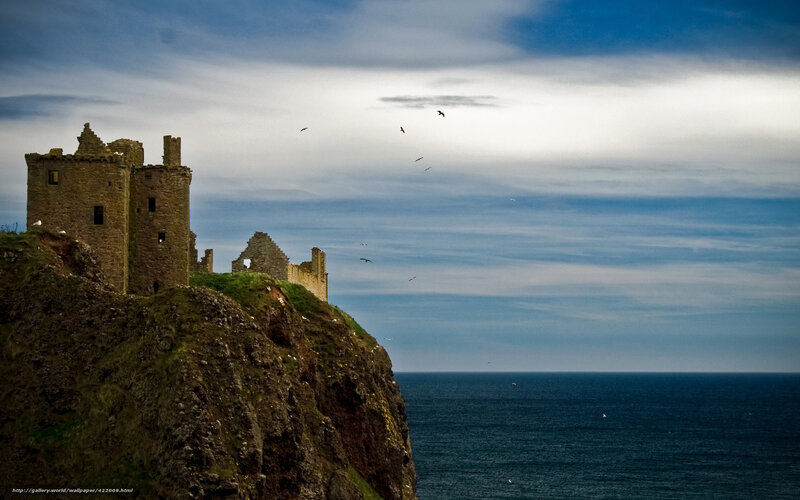 ruined castle on cliff by sea